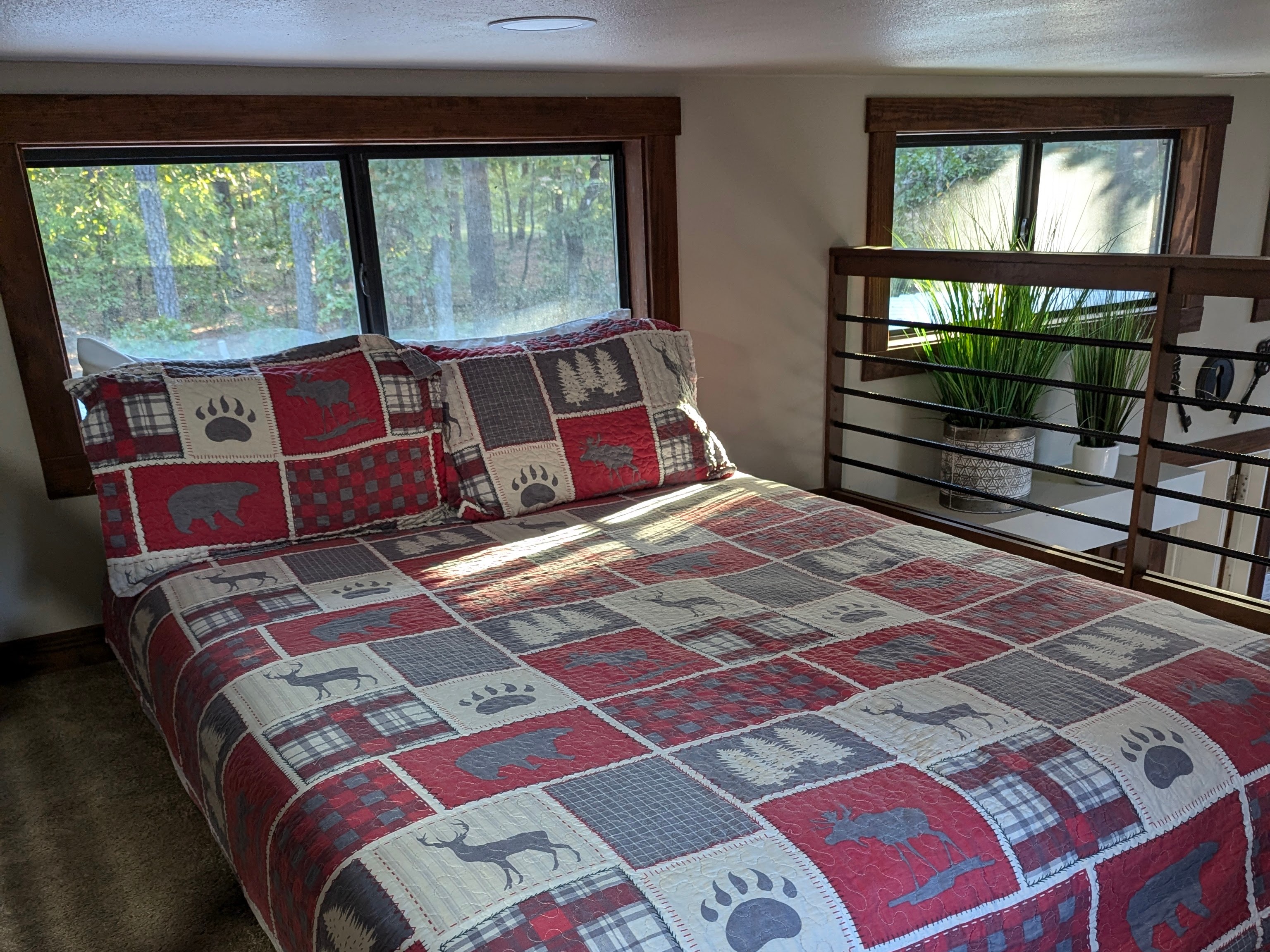 Open loft bed over living area